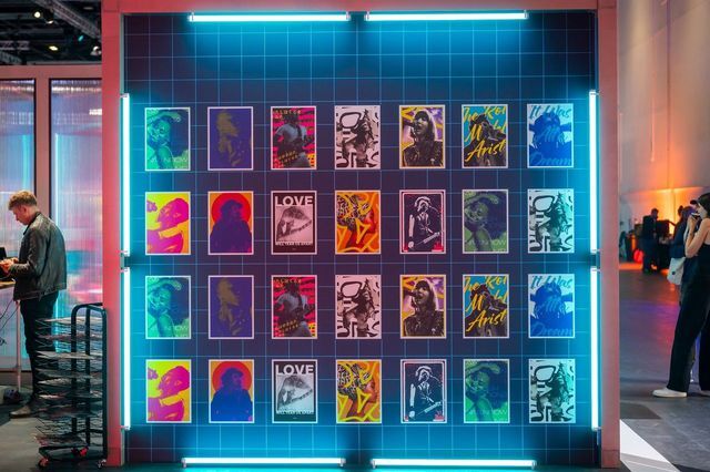 A grid of unique AI-generated album covers displayed on a neon-lit wall at Xerocon, created by INVNT